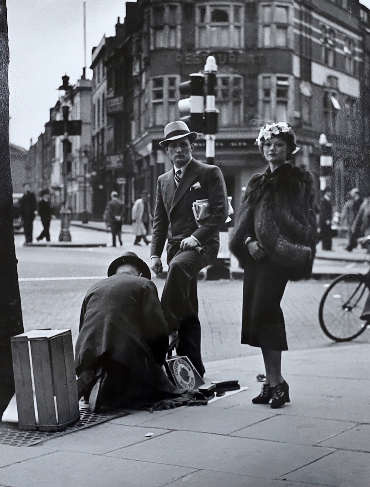Wolfgang Suschitzky (Austrian/British, 1912-2016), gelatin-silver print, 'Charing Cross Road, shoe-shine', signed verso, 36 x 29cm